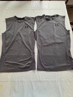Two UA sleeveless compression shirts, Mens size M